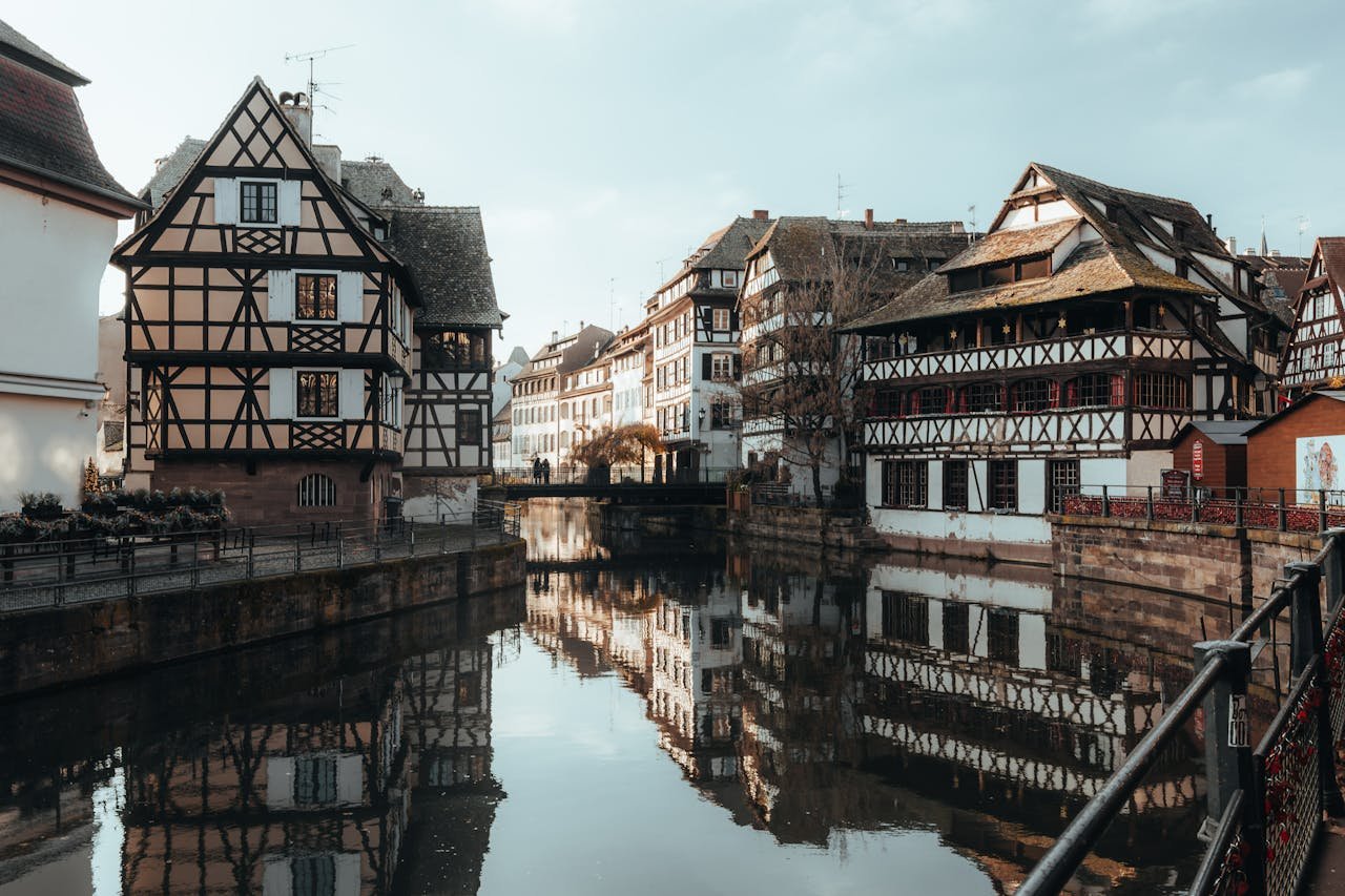 Picturesque view of half-timbered houses reflected in a canal, Strasbourg, France.